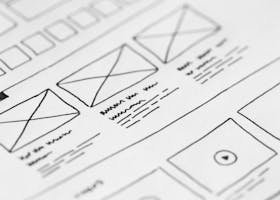 Detailed close-up of a hand-drawn wireframe design on paper for a UX project.